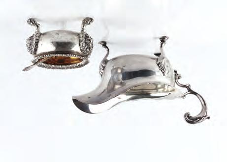 AN EDWARDIAN SILVER SAUCE BOAT, with foliate capped scroll handle on hoof feet, by Crichton Bros, London 1909, 12cm high, 11.