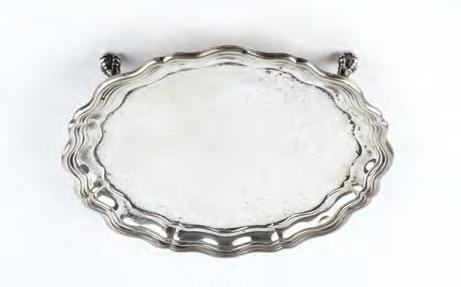 AN EDWARDIAN SILVER SALVER, with shaped border, on claw and ball feet by James Dixon & Sons Ltd, Sheffield 1909, 21cm diameter, 14oz