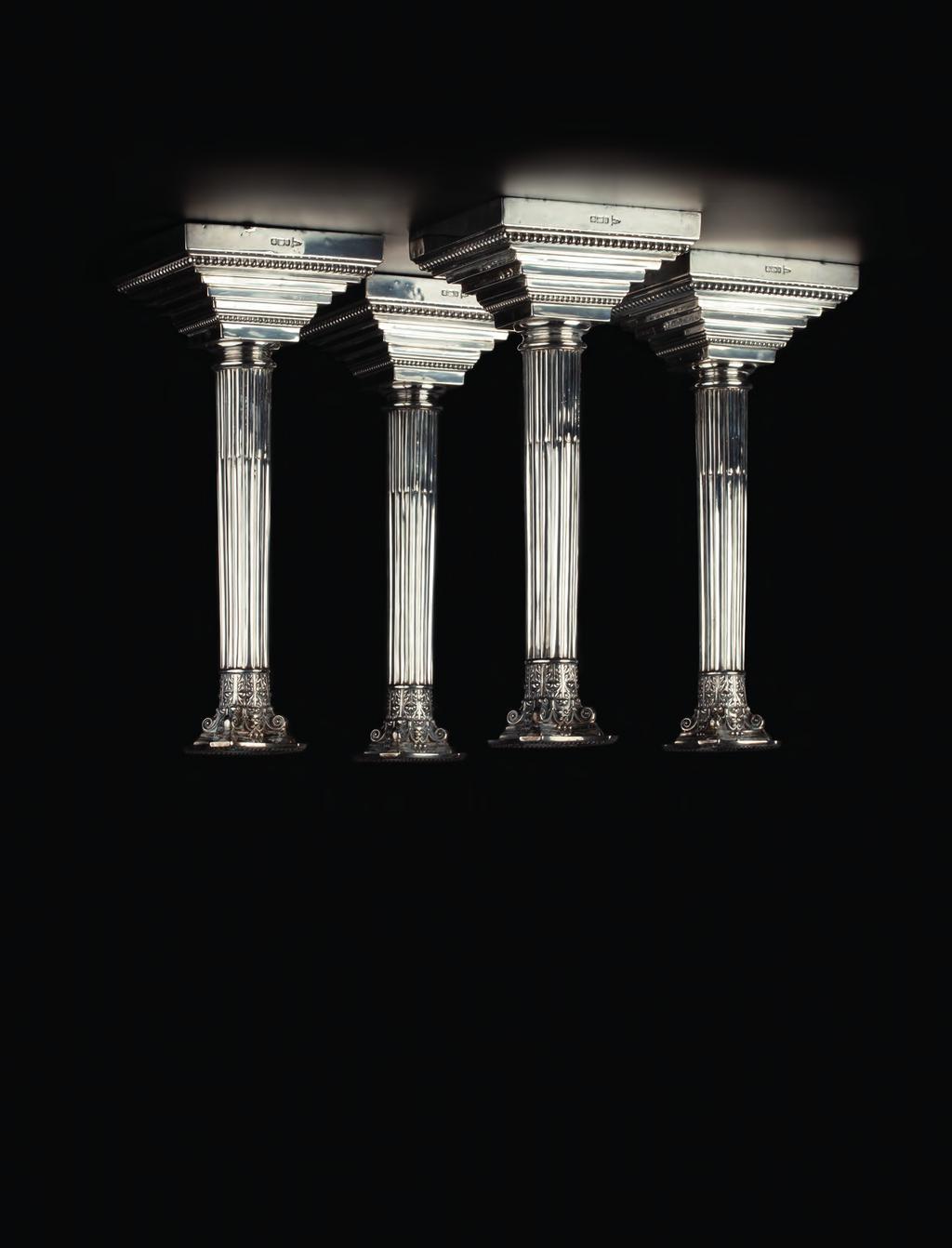 742. A SET OF FOUR EDWARDIAN SILVER CANDLESTICKS, of Corinthian column form, on stepped and