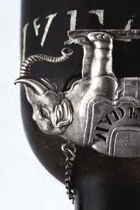 A DANISH SILVER DECANTER LABEL FOR MADEIRA, by Georg Jensen, import marks for 1925, of waisted form, with raised lettering and stylised sinuous foliate