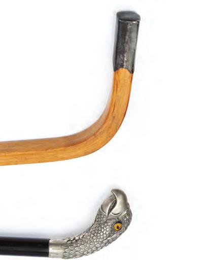 390. A LATE 19TH CENTURY WALKING CANE, the white metal handle realistically modelled as the head of an eagle,