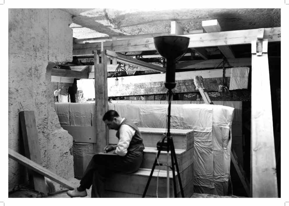 Howard Carter at work in the Antechamber among parts of the dismantled shrines The working conditions inside the small tomb were very difficult.