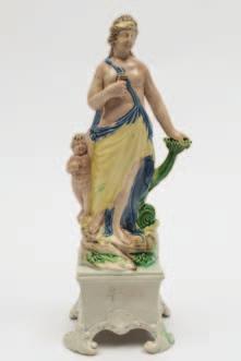 444 A pearl glazed figure of Ralph Wood type modelled as a classical figure flanked by a dolphin and cupid on a shell and foliate moulded