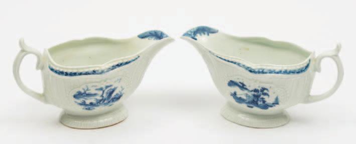 465 467 466 465 A pair of Worcester First Period porcelain sauceboats of press moulded form with panelled fluted exteriors painted in blue