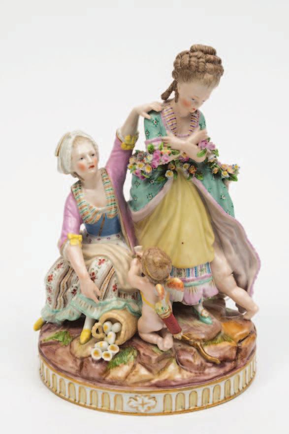 483 A Marcolini Meissen porcelain figure group Broken Eggs modelled after the original by Michael Victor Acier with a pair of female figures, one with a garland and a cherub beneath her skirts with a