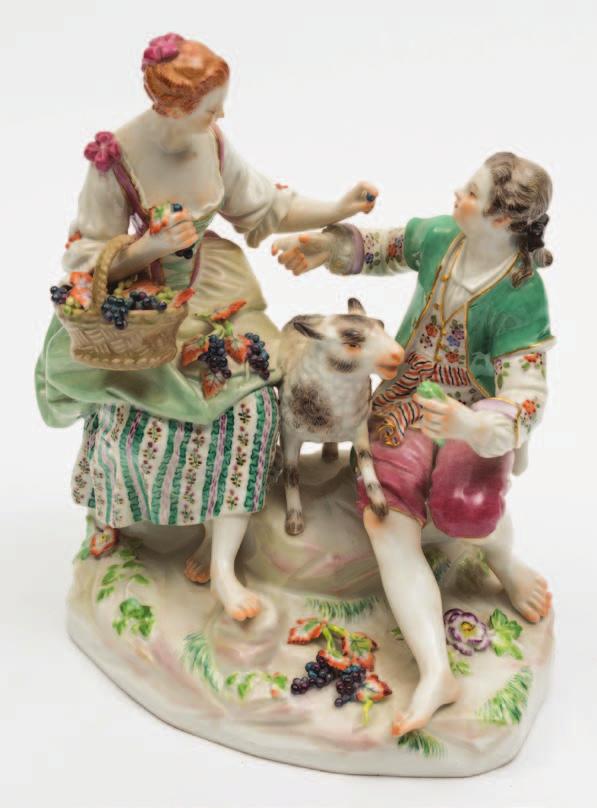 484 A Meissen porcelain group of a shepherd and shepherdess modelled after the original by Michael Victor Acier with a seated barefooted couple flanking a lamb, she with a basket of grapes on one arm