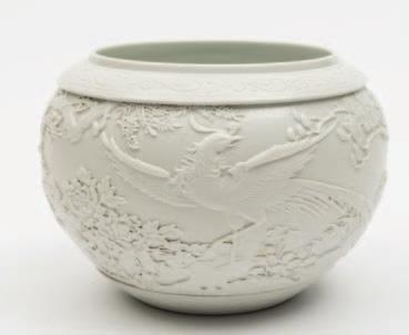 419 A Chinese white glazed porcelain bowl of ovoid form, a raised band to the rim and foot rim incised with scrollwork, relief