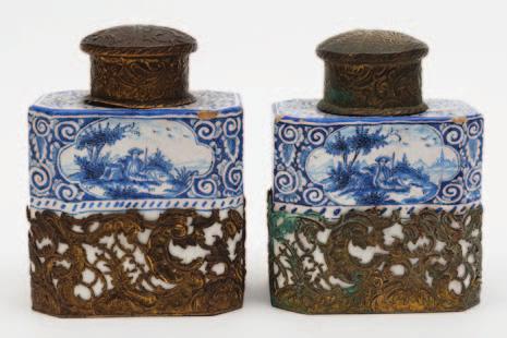 150-180 429 A pair of Dutch Delft tea canisters of canted rectangular form, the upper section of each painted in blue with a quatrelobed panel containing a young lover seated with a letter in a