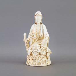 115 Large Blanc-de-Chine Figure of Guanyin Perched on a rocky pedestal, the figure seated with one arm