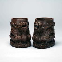 7 22, each with studio mark to base 15 Two Stoneware Dragon Brushpots Of oval-shape and decorated with two