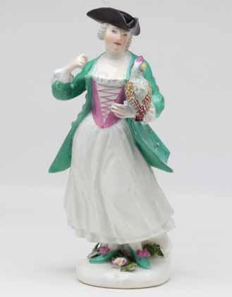 11. A Meissen figure of a Falconer, standing, wearing a white skirt and turquoise hunting coat, and black tricorn hat, and holding a falcon on her left hand,