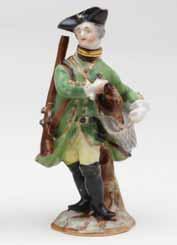 26. A Meissen scent bottle and stopper, in the form of a sportsman, standing, wearing a green hunting coat and gilt trimmed black tricorn hat, carrying a gun over