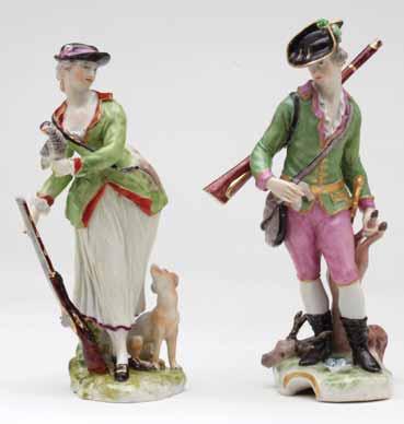 A pair of Ludwigsburg figures of a sportsman and woman, he wearing puce breeches, a puce and gilt trimmed green hunting coat, and gilt bordered black hat, dragging a dead stag with his left hand, a