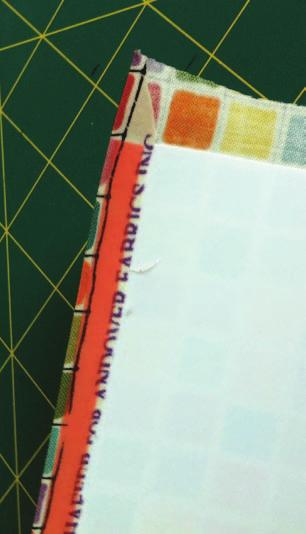 Trim along the lines you have drawn on both the top and bottom long edges. Tape lies just in from the folded edge. 12.