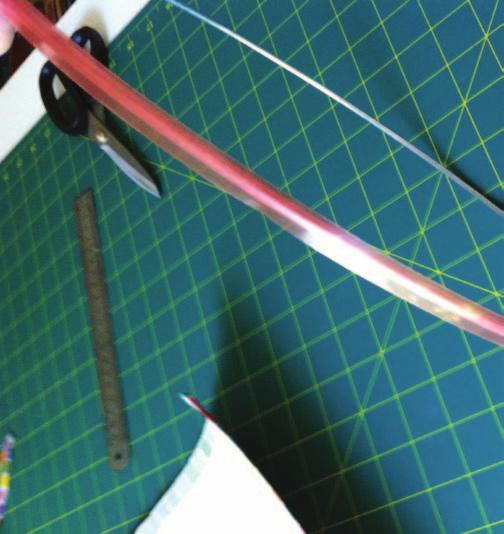 JOINING THE PVC TO THE RINGS Now you can assemble your lampshade by attaching the PVC to the rings. 13. Apply a strip of the clear tape to the folded end.