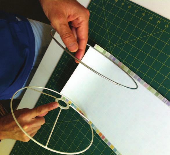(ABOVE) Apply the red double-sided tape to the outside edges of both lampshade rings.