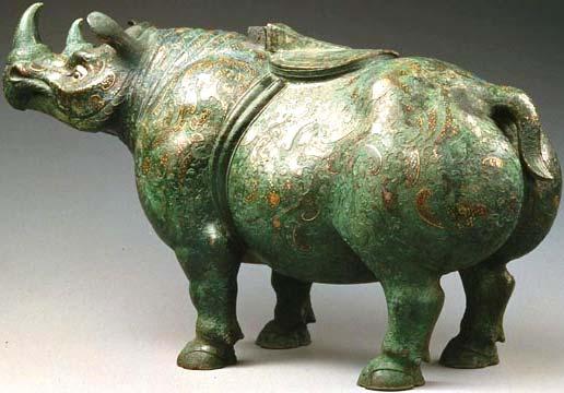 a b c Figure 19 a) Bronze inlaid with gold, tiger devouring a deer, Tseng collection, CSUN, Warring States Period. b) Bronze human head with gold leaf, Late Shang Period (c.
