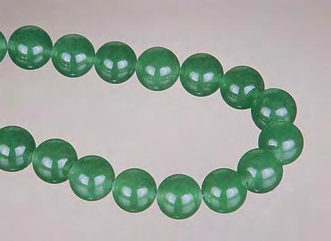 fact, many of these issues have continued into the new millennium. Figure 16. Quartzite dyed green to imitate jadeite, as illustrated by these 8 mm beads, was commonly seen in the 1990s.
