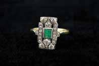 each of two slightly graduated rectangular rubover central emerald pave diamond