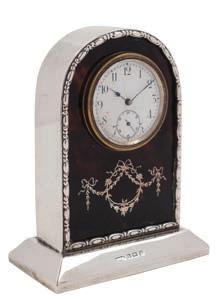 Arabic dial, with inlaid tied garland decoration below, on a rectangular plinth base, 11.5cm. high. * 200-250 133-4 No Lots.