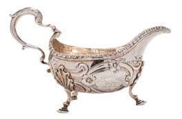 167 167 A George III silver sauceboat, maker George Smith II, London, 1763 crested, of traditional design with beaded border, acanthus capped scroll handle, having scroll and foliate decoration to
