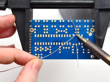 The resistor sits flat right up against the PCB and the leads hold it in place when bent Now you'll solder!