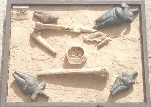 Tomb 626 The four "idols" lying around the skeleton remains appear to be guards and companions. The ancient people had an idea of the four cardinal directions of the World. This is a female's burial.