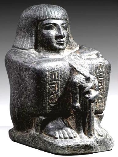 He is wearing a decorated Khat headdress and there is a small figure between his feet. Fig.4 Block statue of Sau-Hor [15]. Fig.2 Statue of Osarkon the Elder [13].