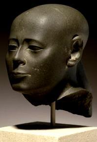 The designer showed the Pharaoh wearing a decorated Nemes headdress with a symbol on its front. Fig.30 Head Of Priest Wesirwer [43]. Fig.28 Head of Pharaoh Amasis II [41]. B.