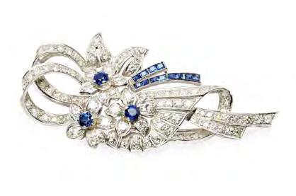 Jewellery, Silver, Watches & Wine 27 Sapphire Jewellery 122 A sapphire and diamond set three stone ring claw set with a cushion cut sapphire, flanked to either side by a round brilliant cut diamond,