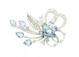 148 A zircon and diamond set brooch of open scrolling and floral form, claw set with a central cluster of round and cushion cut zircons, set throughout with small round brilliant and eight cut