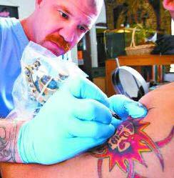 The Salinas Californian: July 13, 2004 Kurt Brux, tattoo artist and owner of West Coast Tattoo, applies his artwork on the arm of