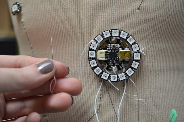 Secure the NeoPixel ring to the garment with plain thread.