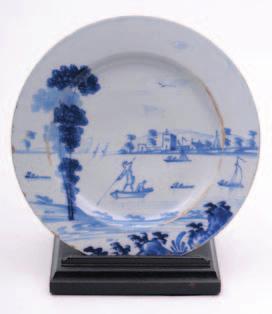 An English, probably Bristol, delft charger painted in blue with three cranes in a naive garden
