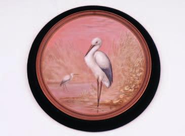 A Watcombe pottery plaque of circular form with beaded and moulded border, the centre finely enamelled by Alexander Fisher with a pair of Herons in a waterside landscape, A.
