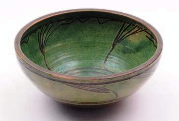 595. Michael Cardew (1901-1983), an earthenware bowl decorated with simple finger trailed designs in green slip over brown, 31 cm diameter, impressed personal and Winchcombe pottery seals. 280-320.