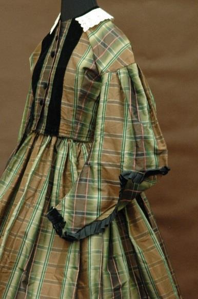 MHCTC s exhibition showcased a variety of plaids in the Collection s holdings, including a 19 th century silk plaid dress pictured to the left (Gift of the Faurot Family) and a 2007 wool tartan kilt