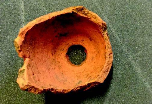 This is the base of a ceramic flower pot. It was found in 1993 as part of the archaeological excavation of the Privy Gardens at Hampton Court.