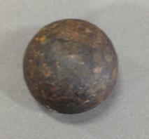This is a cast iron cannon ball, found in the moat at the Tower of London; a very clear sign of the defensive and military history of the Tower. It was probably even fired from the battlements.
