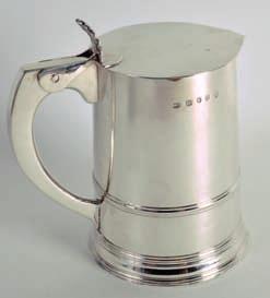 Lot 366 366 A GOOD GEORGE III SILVER FLAT TOP TANKARD of plain form with tapering sides, bearing a central crest of an eagle above a twin ribbed
