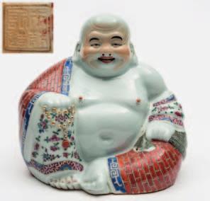 556 A Chinese porcelain figure of a seated Buddha in typical posture wearing a brick decorated robe and holding prayer beads and a