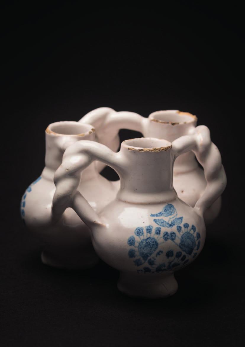 583 A London blue and white delftware fuddling cup in the form of three globular cups with cylindrical necks linked by intertwined handles, each