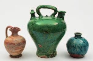 584 A Roman pottery ewer, a Spanish botiga and a small jar the first decorated with iron-red concentric bands, 16 cm; the second glazed in green, 25 cm; the