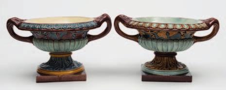 200-400 604 A close pair of Doulton Lambeth majolica urns of squat campana form, moulded with a band of fruiting