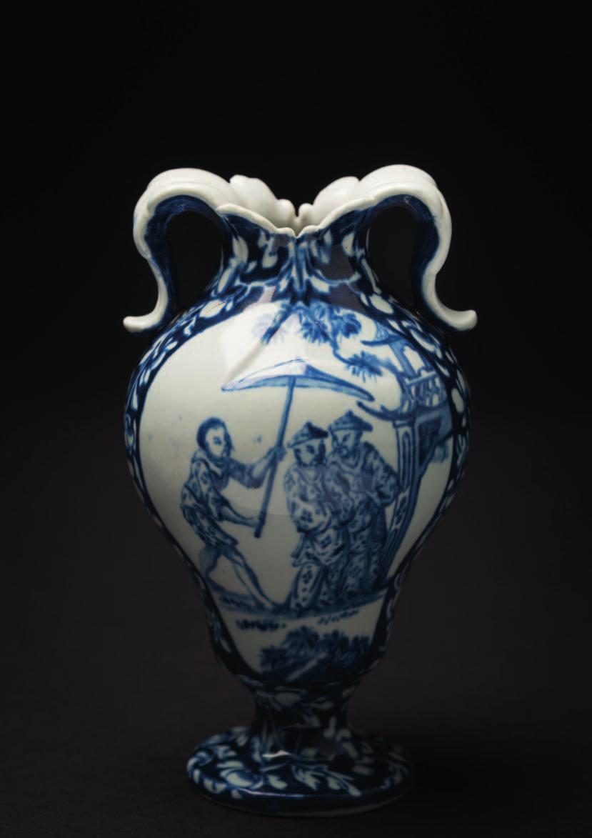 642 A rare Vauxhall blue and white vase of ogee form with foliate scrolled handles, painted with panels depicting an extensive oriental lake landscape, the reverse with an attendant holding a parasol