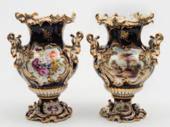 662 A pair of Coalbrookdale porcelain pedestal vases each with foliate moulded foot, handles and rim, the body and foot enamelled with panels containing