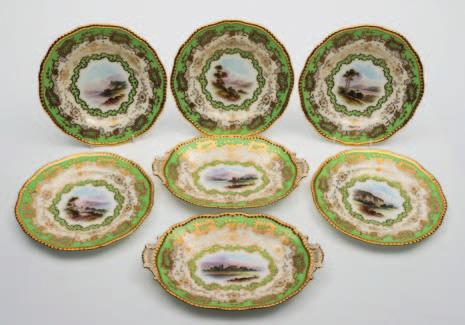 675 A part Coalport porcelain dessert service comprising five plates of silver shape and two oval two handled dishes, all with gilt gadrooned rims, the centre