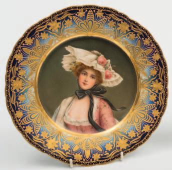 150-180 681 A Vienna-style porcelain plate painted with a portrait of the Queen of the Roses, the rim elaborately gilded with flowers and foliage in the art nouveau manner on
