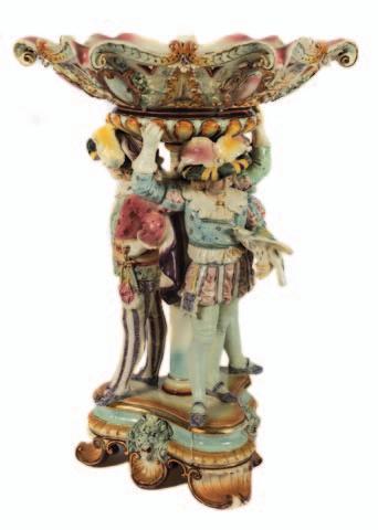 150-200 681 683 684 683 A large Royal Dux Bohemia porcelain centrepiece modelled with three barefoot girls dancing around a tree supporting a large flower decorated basket,