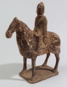 522 A Chinese sancai glazed equestrian figure of a warrior wearing ornate tunic and decorated in lead glazed green,